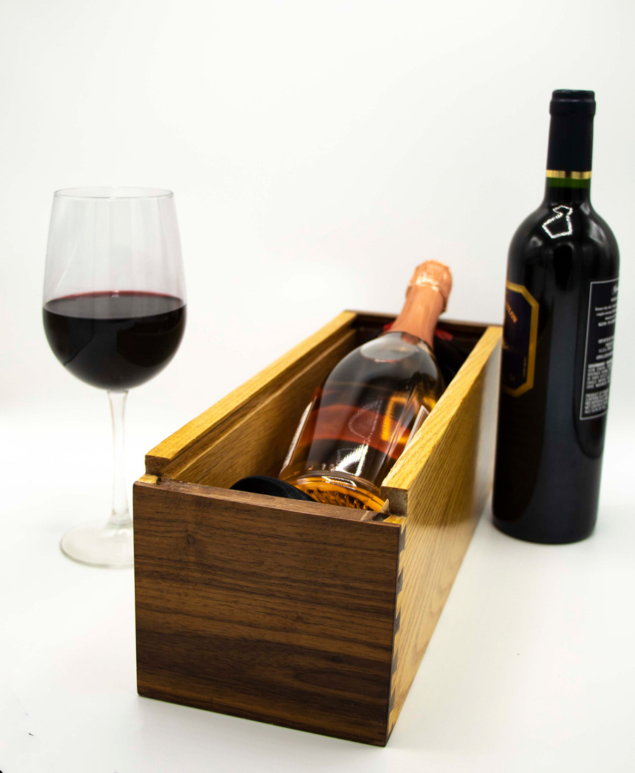 Wine box made from 2 woods. Paduk is red. Oak is light blonde.