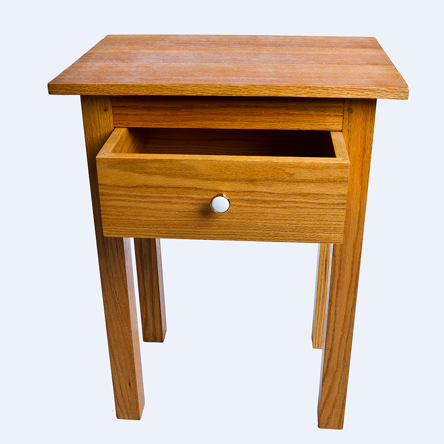 Light wood table with one drawer.